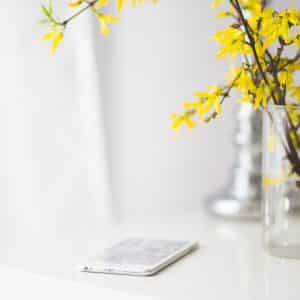iphone on desk with flowers